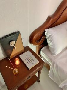 a table with a book on it next to a bed at Apartaestudio 102 - Casa RURAL - Brisas del Campo in Girón