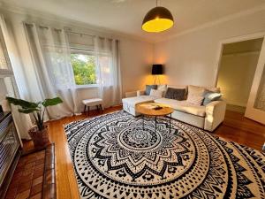 - un salon avec un canapé et un tapis dans l'établissement 1 Bedroom Art Deco Apt With Study, à Prahran