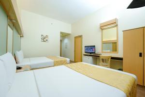 Postel nebo postele na pokoji v ubytování Microtel by Wyndham Davao