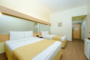 Postel nebo postele na pokoji v ubytování Microtel by Wyndham Davao