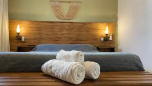 a bedroom with two beds with towels on the floor at Alojamiento en el centro de Salta - Casaguemessalta in Salta