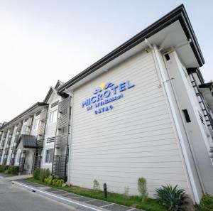 a building with a sign on the side of it at Microtel by Wyndham Davao in Davao City