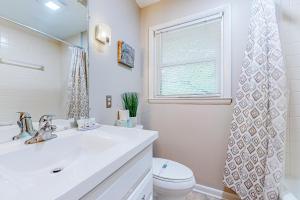 a bathroom with a sink and a toilet and a window at Sunny Retreat in Lake Junaluska +16 photos