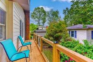 a balcony with two chairs and a house at Sunny Retreat in Lake Junaluska