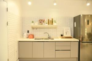 a kitchen with a sink and a refrigerator at Hotel Rawa in Seoul