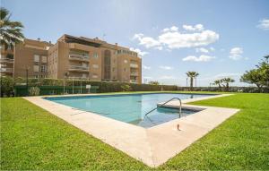 a swimming pool in the grass in front of a building at Gorgeous Apartment In Malaga With House Sea View in Málaga