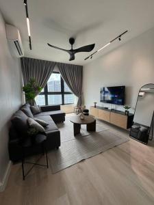 a living room with a couch and a tv at M Vertica Residence in Kuala Lumpur