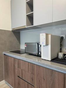 a kitchen with a counter top with a microwave at M Vertica Residence in Kuala Lumpur