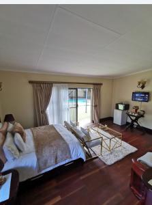 a bedroom with a large bed and a sliding glass door at Exclusive Private Room in Joburg No loadshedding in Johannesburg