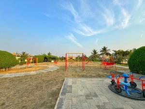 a playground with a bike parked in a park at marine beach villa in Damlawari