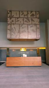 a lobby with a reception desk in a building at LUCENTIA RESIDENCE By LALAPORT in Kuala Lumpur +144 photos