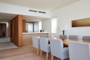 a dining room with a wooden table and chairs at 葉山 Syla Hotel Zushi-Hayama in Yokosuka