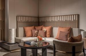 a living room with a couch and a table at Four Seasons Hotel Osaka in Osaka