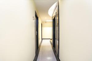 a hallway with two doors and a wall at FabHotel Shubhangan in Mumbai