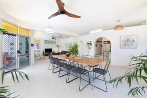 a dining room and living room with a table and chairs at 'Arafura Blue' a Poolside Family Oasis on the Coast in Darwin