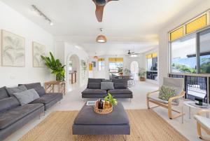 a living room with a couch and a table at 'Arafura Blue' a Poolside Family Oasis on the Coast in Darwin