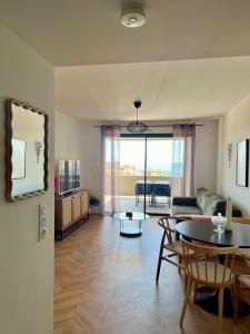 a living room with a table and a couch at T2 Ajaccio vue mer in Ajaccio