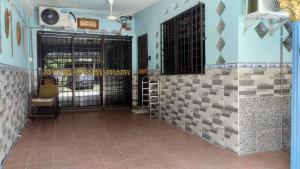 Pokój z drzwiami i ścianą wyłożoną kafelkami w obiekcie Maktok's Nilai Homestay w mieście Nilai