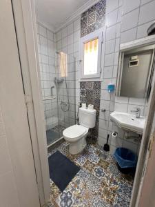 a bathroom with a toilet and a sink at Downtown Sea View Suites in Alexandria