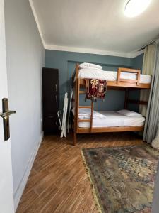 a room with two bunk beds and a rug at Downtown Sea View Suites in Alexandria