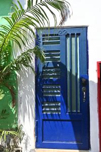 a blue door on the side of a house at Casa Baluana vive Sayulita a un paso de todo in Sayulita