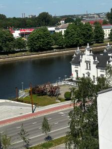 a large white building next to a body of water at Liela Studio Liela Street in Liepāja
