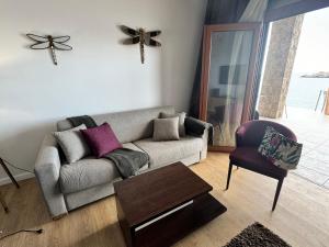 a living room with a couch and a chair at Apartments Lungo Mare in Sveti Stefan