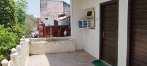 an open door of a house with a balcony at Hotel Host near Taj in Agra