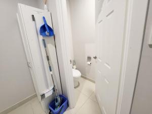 a bathroom with a toilet and a blue mop at Unit 51 Seafront Estate in Jurien Bay +13 photos