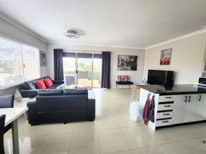 a living room with a couch and a tv at Unit 51 Seafront Estate in Jurien Bay
