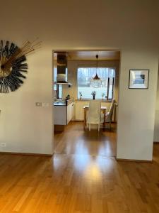 a living room with a table and a kitchen at 3BR Keflavík Home, 8 Min to Airport Sleeps 6 in Keflavík