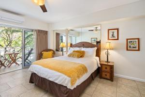 a bedroom with a large bed and a balcony at Waikiki Shore Beachfront in Honolulu