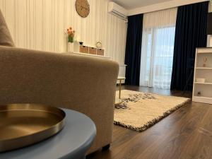 a living room with a couch and a table at Danubius Delta Tulcea in Tulcea