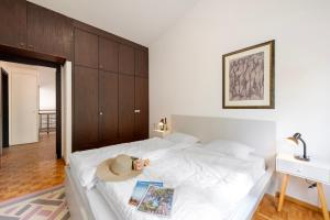 a bedroom with a white bed with a hat on it at BoReal Apartments in Paradiso