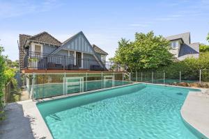 a swimming pool in front of a house at Poolside Stay - Close to Taronga Zoo & Luna Park in Sydney