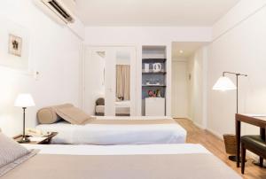 מיטה או מיטות בחדר ב-Loi Suites Esmeralda