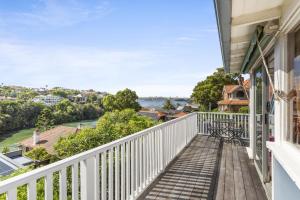 a balcony with a view of the water at Poolside Stay - Close to Taronga Zoo & Luna Park in Sydney