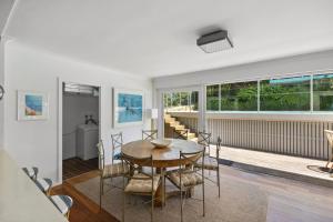 a dining room with a table and chairs at Poolside Stay - Close to Taronga Zoo & Luna Park in Sydney