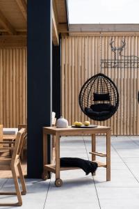 a room with a table and a bird cage at Chaletovo Mountain Residences in Zakopane