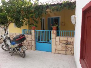 a motorcycle parked in front of a house at Vintage House-Vori-Rent Rooms in Vóroi