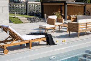 a group of chairs sitting next to a pool at Chaletovo Mountain Residences in Zakopane