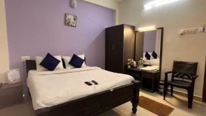 Postel nebo postele na pokoji v ubytování Srichand Business Class Rooms + 14 fotografií