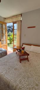 a bedroom with a large bed with a table on it at Casa de Campo Chinkay - Lunahuana in Lunahuaná +34 photos