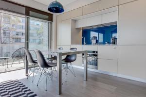 a kitchen with a dining table and chairs at Explore Sydney from Stylish North Shore Apartment in Sydney