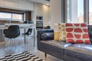 a living room with a couch and a kitchen at Professional living minutes from the city in Sydney