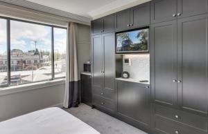 a bedroom with gray cabinets and a window at Perfect Located 2-Bed Blue Mountains Getaway in Katoomba