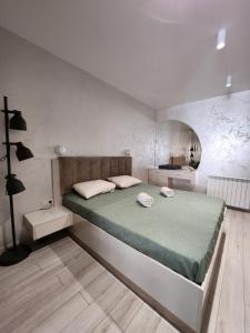 a bedroom with a large bed in a room at Мери in Varna City