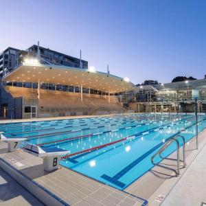 a large swimming pool in front of a building at Sunny Apartment in Quiet and Green Neighbourhood in Sydney