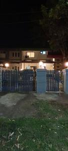 een blauw hek voor een huis 's nachts bij Blue Heaven- Lonavala 2 Bhk with private pool! in Lonavala