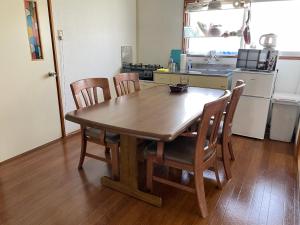 a wooden table and chairs in a kitchen at Azumi Relax Lodge 2 in Azumino
